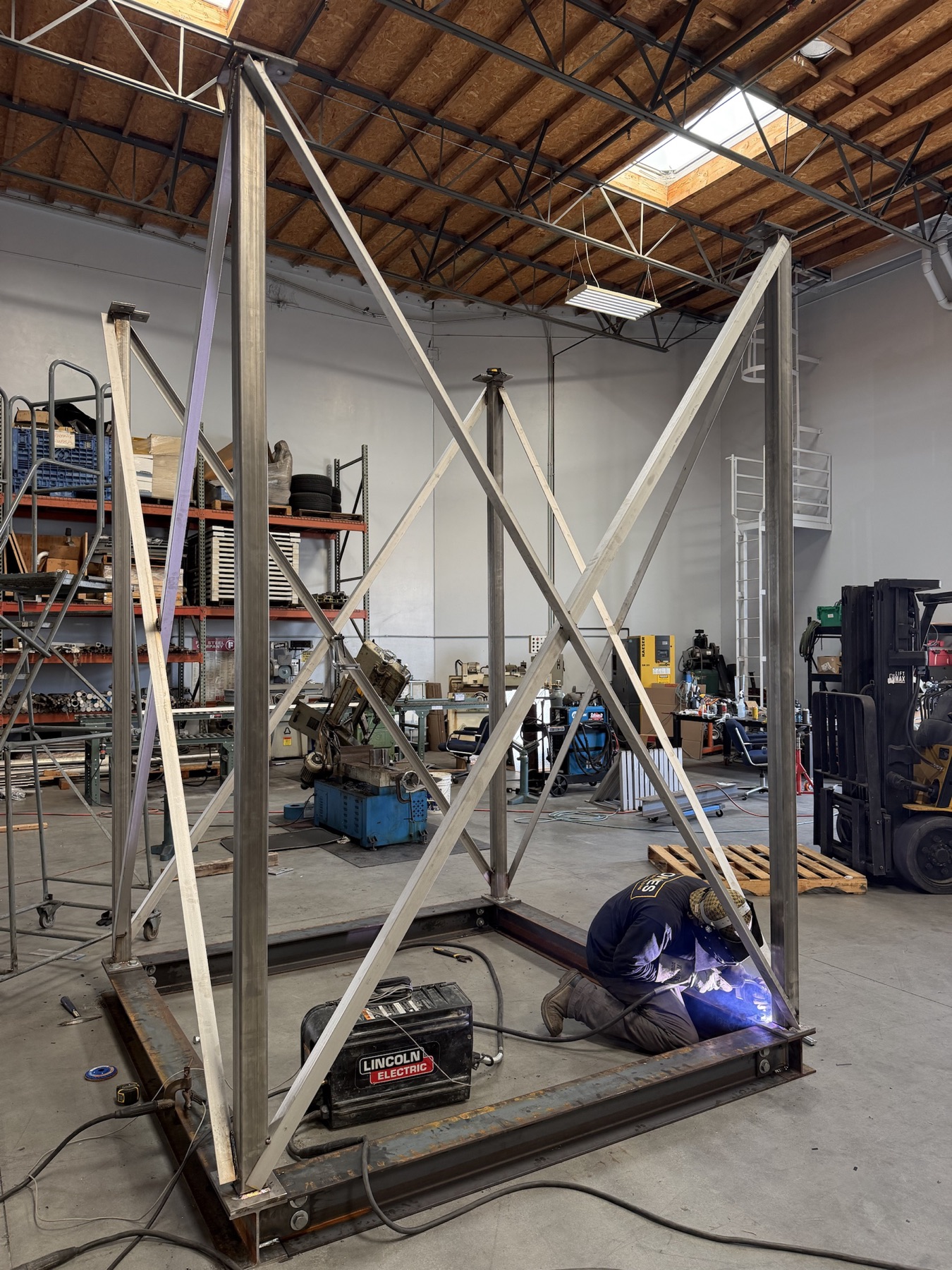 Jones welder constructing a large structural frame in the fabrication facility