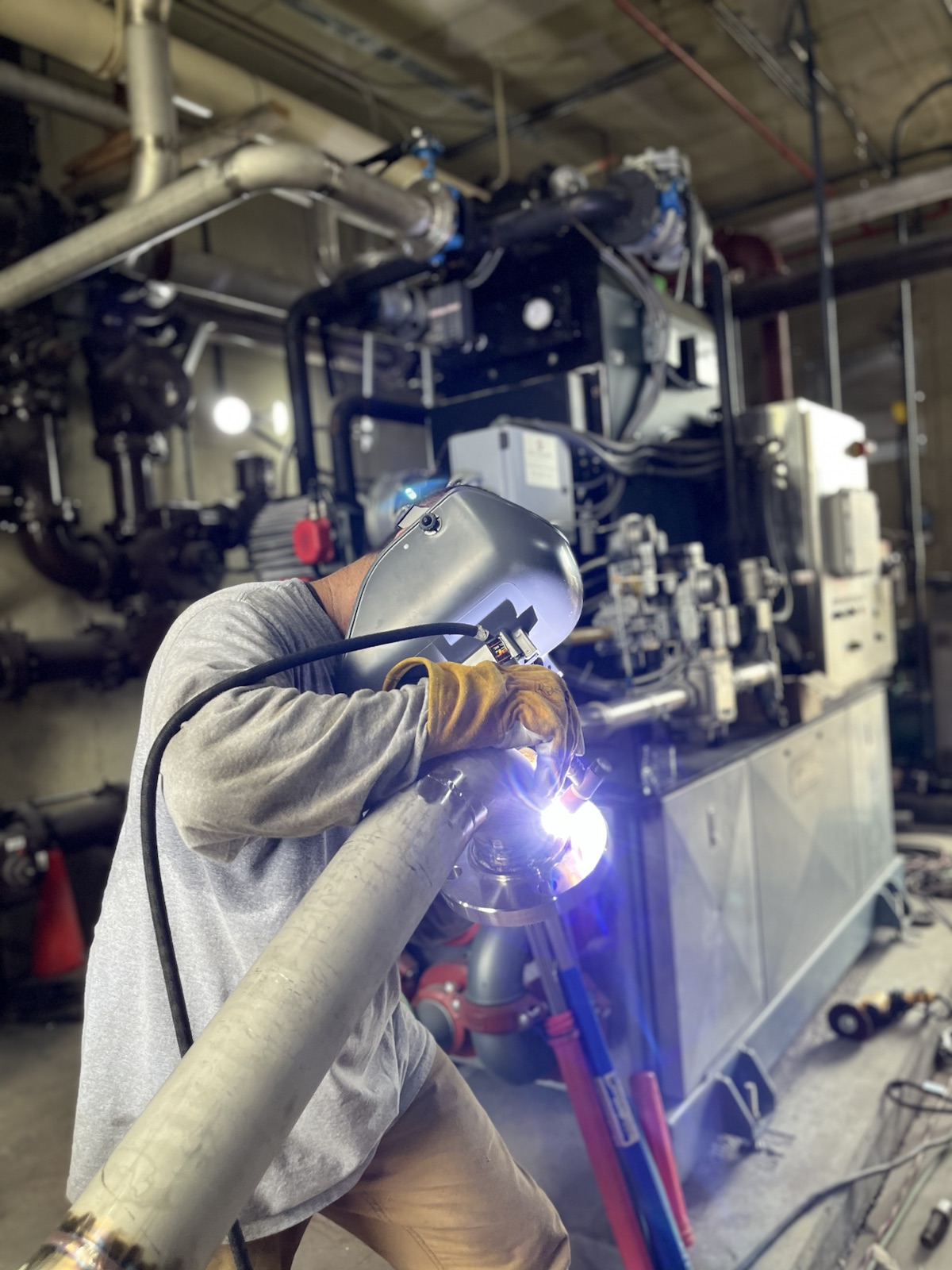 Jones welder working on industrial equipment in the field