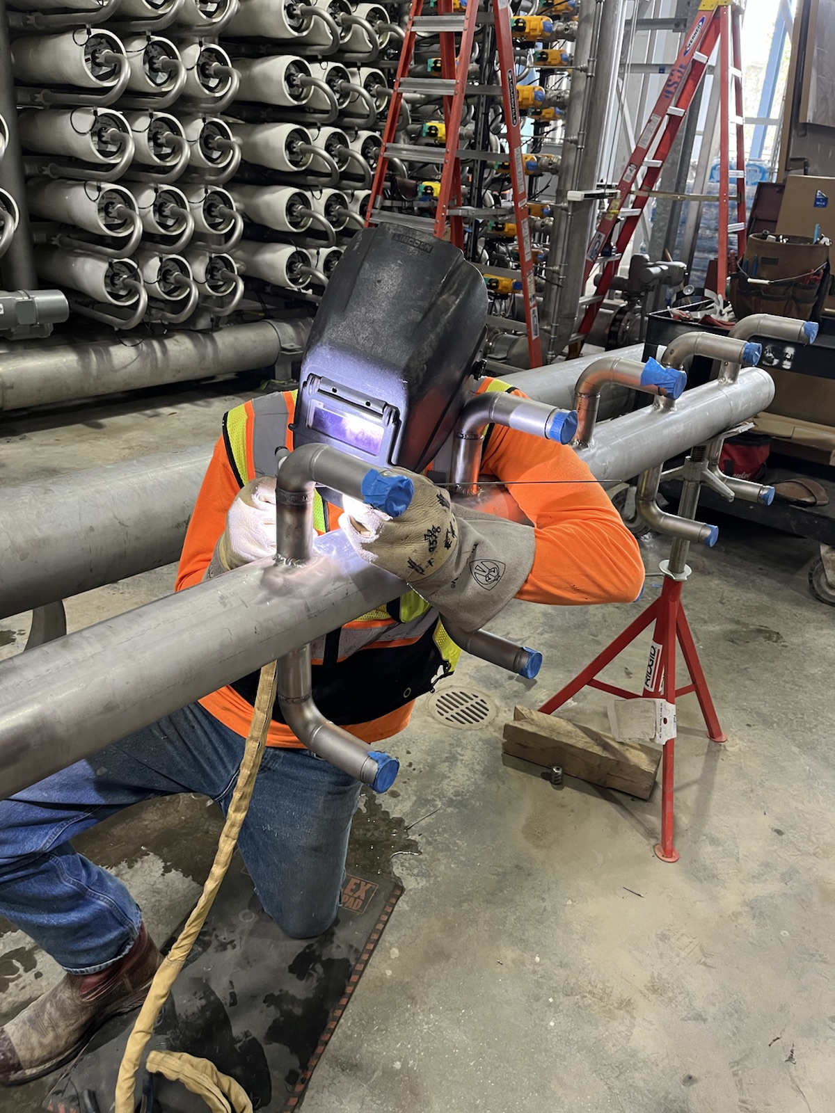 Jones welder fabricating stainless process piping on site